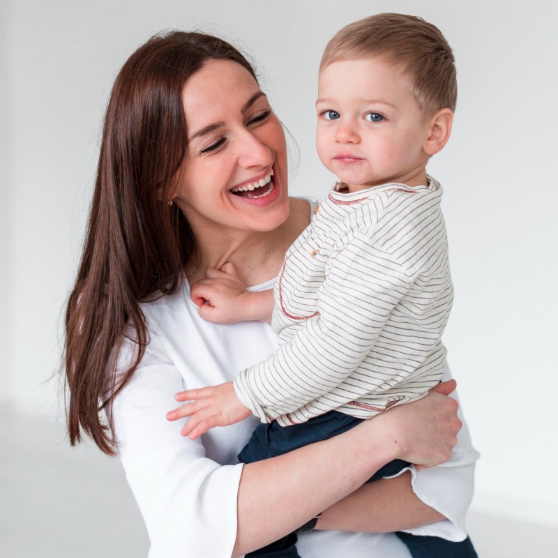 smiling mother with baby at Brooklyn doctor's office